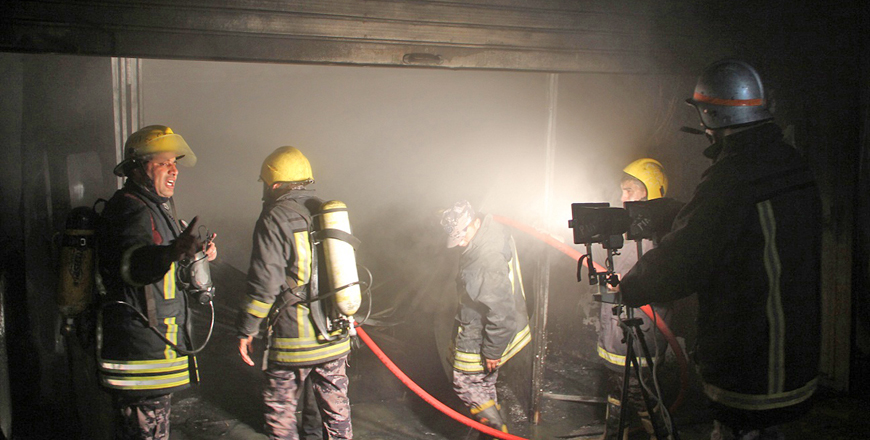 Firefighters extinguish a blaze at a car painting shop in Bayader, Amman, on Friday (Petra photo)